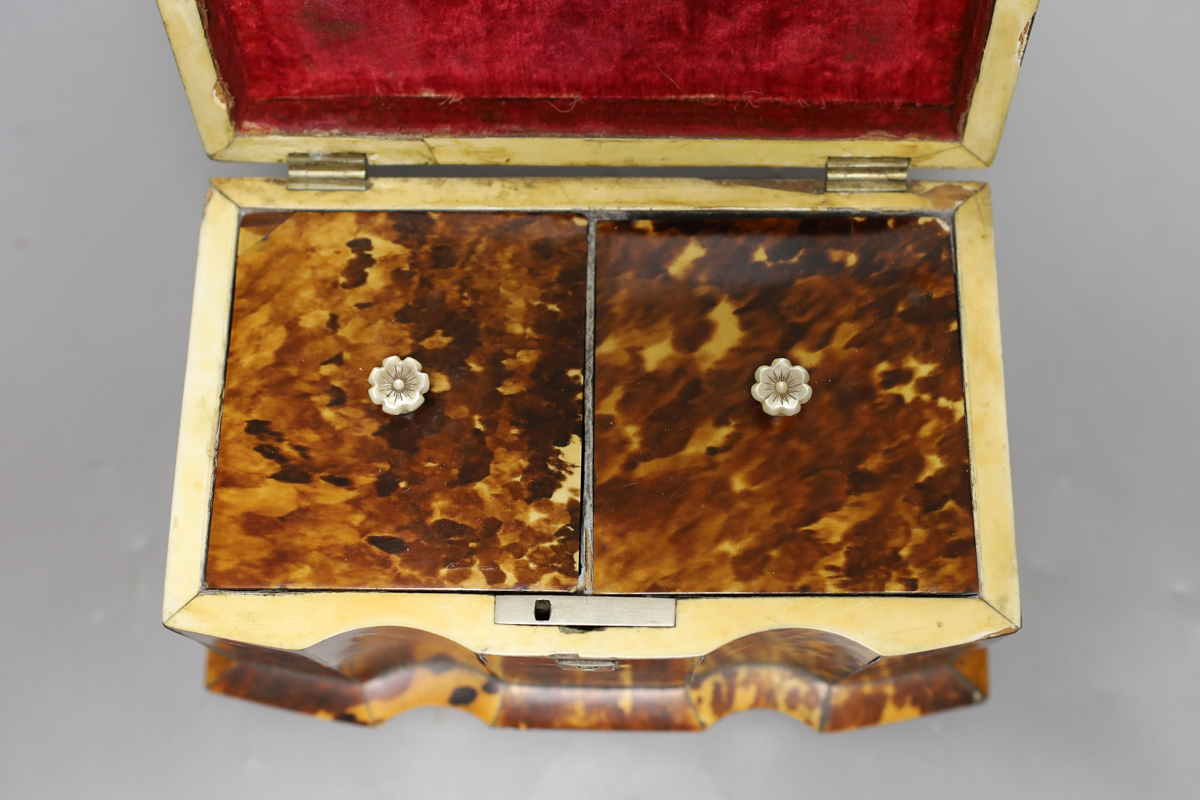 A 19th century tortoiseshell veneered tea caddy, ivory veneered edging, 20cms wide